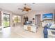 Inviting living room with vaulted ceilings, wood-look tile flooring, and comfortable seating arrangements at 10075 Bentley Ave, Englewood, FL 34224