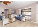 Cozy living space featuring comfortable furnishings, a decorative ceiling fan, and access to sunroom at 10075 Bentley Ave, Englewood, FL 34224