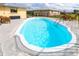 Sparkling pool surrounded by a concrete deck with patio furniture, perfect for entertaining and enjoying the outdoors at 10075 Bentley Ave, Englewood, FL 34224