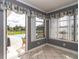 Sunroom with a window view of the pool, a ceiling fan, and neutral-colored walls at 10075 Bentley Ave, Englewood, FL 34224
