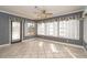 Sunroom features a ceiling fan and a large window view of the surrounding backyard and landscaping at 10075 Bentley Ave, Englewood, FL 34224