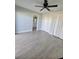 Bedroom featuring wood-look tile flooring, closet space, and view into the bathroom at 1247 Price Nw Cir, Port Charlotte, FL 33948