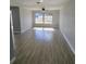 Bright living room featuring tile flooring, large windows, and modern neutral paint at 1247 Price Nw Cir, Port Charlotte, FL 33948