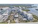 An aerial view of the condo community, marina, tennis courts, pool, landscaping, and waterfront at 13313 Gasparilla Rd # 404, Placida, FL 33946