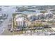 Aerial view of waterfront condos offering boat docks and resort-style amenities, including a pool and tennis court at 13313 Gasparilla Rd # 404, Placida, FL 33946