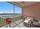 Relaxing screened balcony with comfortable seating arrangements and scenic water views, perfect for unwinding at 13313 Gasparilla Rd # 404, Placida, FL 33946
