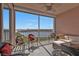 Spacious screened balcony with comfortable seating and ceiling fan, offering panoramic waterfront views at 13313 Gasparilla Rd # 404, Placida, FL 33946