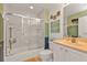 Bathroom with shower and tub combo, complemented by vanity, framed artwork, and bright interior paint at 13313 Gasparilla Rd # 404, Placida, FL 33946
