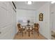 Cozy dining area with a glass-top table, woven chairs, and natural light at 13313 Gasparilla Rd # 404, Placida, FL 33946