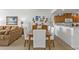 Cozy dining area with seating for six next to kitchen and living room with beach-themed decor at 13313 Gasparilla Rd # 404, Placida, FL 33946