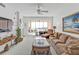 Well lit living room with comfortable seating and sliding glass doors to a balcony at 13313 Gasparilla Rd # 404, Placida, FL 33946