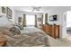 Main bedroom with a palm-themed decor, bedside tables, ceiling fan and ensuite access to balcony at 13313 Gasparilla Rd # 404, Placida, FL 33946