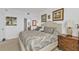 Main bedroom with a palm-themed decor, bedside tables, and an ensuite bathroom at 13313 Gasparilla Rd # 404, Placida, FL 33946