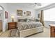 Bright bedroom with a palm-themed decor, bedside tables, and a ceiling fan at 13313 Gasparilla Rd # 404, Placida, FL 33946