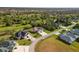 Aerial view of the house nestled in a well-maintained neighborhood with mature trees and lush landscaping at 1332 Hedgewood Cir, North Port, FL 34288