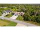 Overhead view of the house in a quiet neighborhood surrounded by lush greenery and well-maintained lawns at 1332 Hedgewood Cir, North Port, FL 34288