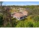 Expansive aerial view of single-story home showcasing its lush surroundings and neighboring houses at 1332 Hedgewood Cir, North Port, FL 34288