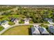 Aerial view of the house in a serene community with well-manicured lawns and mature trees at 1332 Hedgewood Cir, North Port, FL 34288