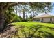 Expansive back yard featuring lush greenery and plenty of space for outdoor activities at 1332 Hedgewood Cir, North Port, FL 34288