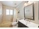 Bathroom with tub and shower, window, and modern vanity with sink and brushed nickel hardware at 1332 Hedgewood Cir, North Port, FL 34288