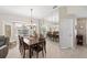 Stylish dining room featuring a large mirror, elegant chandelier, and ample natural light at 1332 Hedgewood Cir, North Port, FL 34288