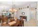Elegant dining room with modern light fixture and mirrored wall feature at 1332 Hedgewood Cir, North Port, FL 34288