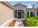 Welcoming front entrance with a screened-in porch, landscaped garden bed, and attractive entryway at 1332 Hedgewood Cir, North Port, FL 34288