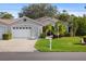 Charming single-story home with well-manicured lawn and attached two car garage at 1332 Hedgewood Cir, North Port, FL 34288