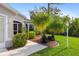 Charming front yard with well-manicured landscaping, a sidewalk, and unique decorative plants at 1332 Hedgewood Cir, North Port, FL 34288