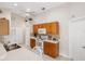 Well-maintained kitchen with white appliances, warm wood cabinetry, and an adjacent breakfast area at 1332 Hedgewood Cir, North Port, FL 34288