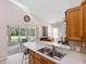 Open kitchen view with countertop seating overlooking the living area and screened lanai at 1332 Hedgewood Cir, North Port, FL 34288