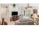 Inviting living room with stylish seating, large TV, bar seating, and a sliding door to the lanai at 1332 Hedgewood Cir, North Port, FL 34288