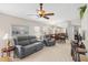 Bright living room featuring tile flooring, ceiling fan, and comfortable seating at 1332 Hedgewood Cir, North Port, FL 34288