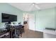 Office space with hard flooring, black computer and chair, as well as wall mounted television at 1332 Hedgewood Cir, North Port, FL 34288