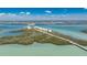 Aerial shot capturing a long, sandy beach with clear turquoise water and palm trees at 1410 Beach Rd # 201, Englewood, FL 34223