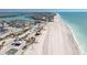 Stunning aerial view of the beach with turquoise water, soft sand, and nearby shops and restaurants at 1410 Beach Rd # 201, Englewood, FL 34223