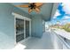 View of balcony with ceiling fan and sliding glass doors at 1410 Beach Rd # 201, Englewood, FL 34223