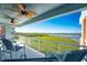 Balcony with patio furniture overlooking beautiful lush vegetation and bay views at 1410 Beach Rd # 201, Englewood, FL 34223
