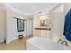 Bathroom featuring a tub, vanity, walk-in shower, and decorative wall art at 1410 Beach Rd # 201, Englewood, FL 34223
