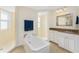 Beautiful bathroom featuring a tub, vanity, and separate walk-in shower at 1410 Beach Rd # 201, Englewood, FL 34223