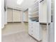 Walk-in closet with multiple shelving units, drawers, and hanging rods at 1410 Beach Rd # 201, Englewood, FL 34223