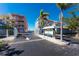 Gated community entrance with lush landscaping, signage, and colorful building exteriors at 1410 Beach Rd # 201, Englewood, FL 34223