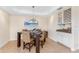 Bright dining area featuring a dark wood table with seating for four and a decorative chandelier at 1410 Beach Rd # 201, Englewood, FL 34223