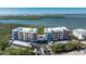 Waterfront condo building with vibrant colors, community pool, and boat docks offers a relaxed coastal lifestyle at 1410 Beach Rd # 201, Englewood, FL 34223