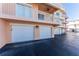 Garage doors beneath condos, offering convenient parking and additional storage space at 1410 Beach Rd # 201, Englewood, FL 34223