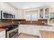 Well-equipped kitchen featuring stainless steel appliances and ample cabinet space at 1410 Beach Rd # 201, Englewood, FL 34223