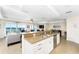 Kitchen island with a sink overlooks the living area with sliding doors to the balcony at 1410 Beach Rd # 201, Englewood, FL 34223