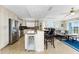 Open-concept living room with island and water view at 1410 Beach Rd # 201, Englewood, FL 34223