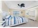 Bright main bedroom featuring a tray ceiling and a decorative ceiling fan and balcony access at 1410 Beach Rd # 201, Englewood, FL 34223