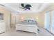 Spacious main bedroom with tray ceiling, ceiling fan, balcony access, and ensuite bathroom at 1410 Beach Rd # 201, Englewood, FL 34223